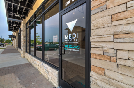 Exterior of a Medi-Weightloss clinic with logo and contact information on the front door.