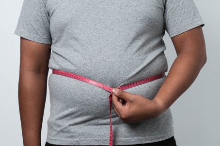 person with a tape measure around waist